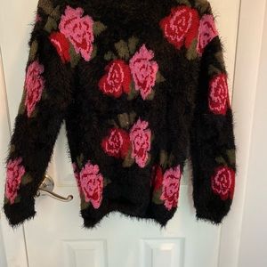 Women’s black sweater with red and pink roses